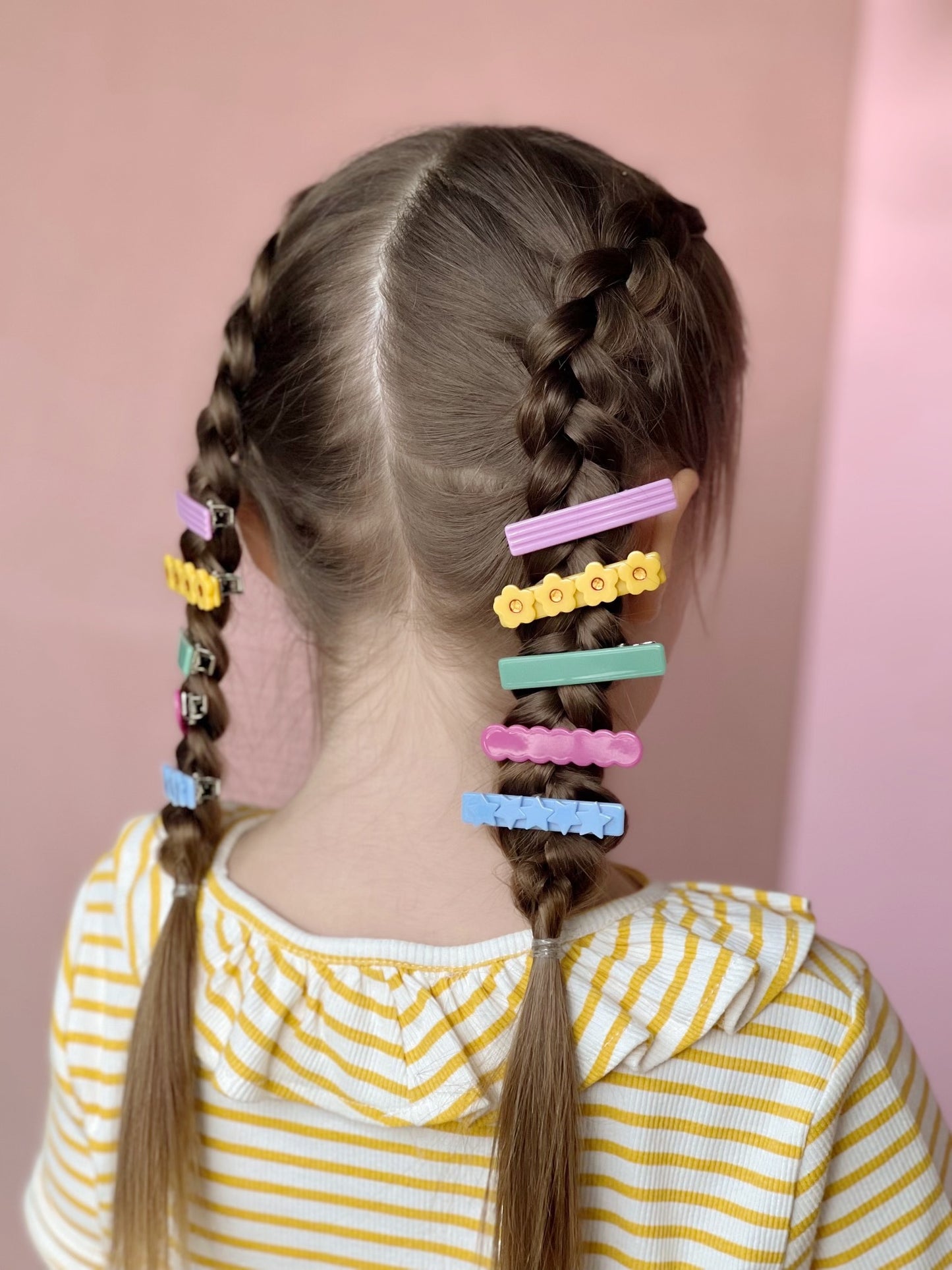 little girl hair style, two dutch french braids with cute and colorful hair clips from bloom and play.