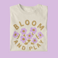 Toddler graphic tee with playful 'Bloom and Play' lilac flowers - Available in sizes 2T to 5T - Embrace childhood fun with this whimsical design.