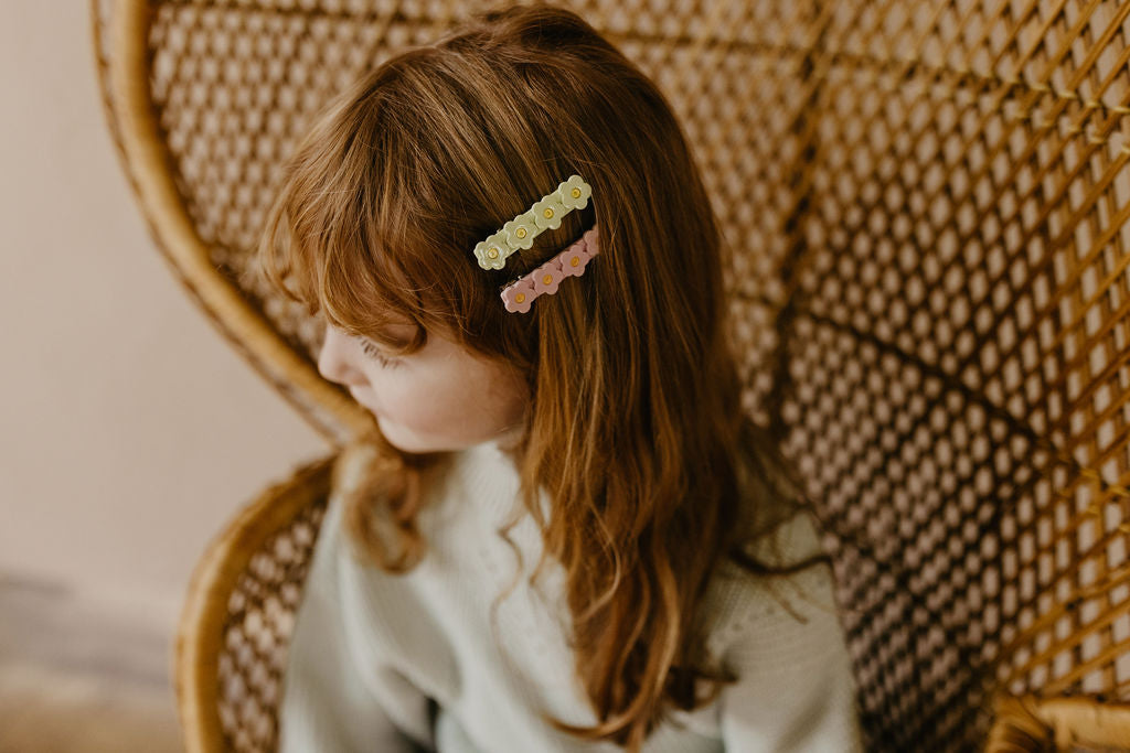 hair clips, green flower clip, pink flower clip on red hair